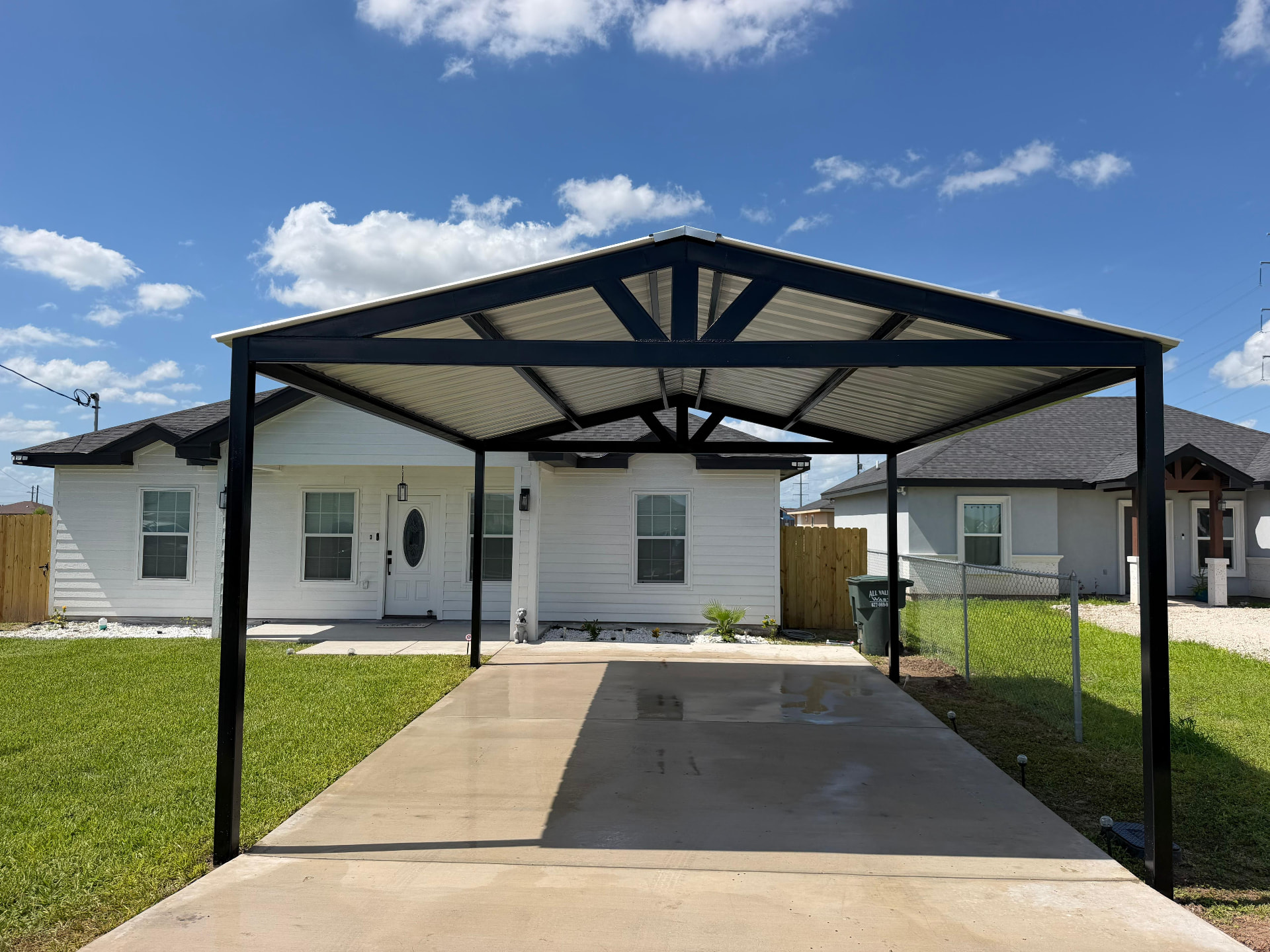 Steel carport over new concrete driveway